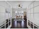 Bright home office with French doors, hardwood floors, and natural light from plantation shutters at 5025 Willing Ct, Fort Mill, SC 29707