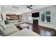 Bright, open living room featuring a fireplace and large windows with views into the kitchen at 5025 Willing Ct, Fort Mill, SC 29707