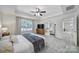 Main bedroom with decorative tray ceilings, plantation shutters, and access to main bathroom at 5025 Willing Ct, Fort Mill, SC 29707