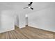 Large bedroom with luxury vinyl plank flooring, ceiling fan, and neutral paint at 504 Christopher Ln, Chester, SC 29706