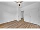 Bright bedroom features hardwood style flooring, ceiling fan, and ample closet space at 504 Christopher Ln, Chester, SC 29706