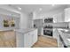 Bright kitchen boasts stainless steel appliances, granite countertops, and an island with open access to living area at 504 Christopher Ln, Chester, SC 29706