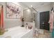 Bright bathroom with a soaking tub, tiled shower, and decorative accents at 512 Park View Dr, Belmont, NC 28012