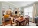 Bright dining room featuring a wood table set for dinner, hardwood floors, and an abundance of natural light at 512 Park View Dr, Belmont, NC 28012