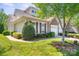 Charming home featuring a two car garage, a stone facade, and beautiful landscaping and manicured lawn at 512 Park View Dr, Belmont, NC 28012