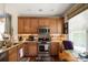 Bright kitchen featuring wood cabinets, granite countertops, stainless appliances, and breakfast area at 512 Park View Dr, Belmont, NC 28012