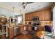 Bright kitchen featuring wood cabinets, granite countertops, stainless appliances, and open concept layout at 512 Park View Dr, Belmont, NC 28012