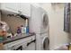 Efficient laundry area with stacked washer/dryer, overhead cabinets, and ample counter space for convenience at 512 Park View Dr, Belmont, NC 28012