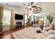 Inviting living room boasts a fireplace, large windows, hardwood floors, and an airy, vaulted ceiling at 512 Park View Dr, Belmont, NC 28012