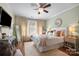 Cozy primary bedroom with bright natural light, decorative mirror, and ceiling fan at 512 Park View Dr, Belmont, NC 28012