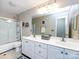 Well-lit bathroom featuring a double vanity, large mirror, and shower-tub combo at 5621 Landale Ct, Concord, NC 28027