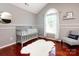 Cozy Bedroom with a crib, chair, neutral colors, and abundant natural light at 5621 Landale Ct, Concord, NC 28027