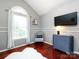 Charming bedroom featuring a chair, television and hardwood floors and sunny arched window at 5621 Landale Ct, Concord, NC 28027