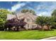 Beautiful two-story brick home with well-manicured lawn and lovely trees at 5621 Landale Ct, Concord, NC 28027