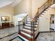 Spacious foyer featuring marble flooring, a staircase with iron spindles and wood handrail at 5621 Landale Ct, Concord, NC 28027