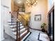 Bright foyer with elegant staircase, chandelier, and marble flooring at 5621 Landale Ct, Concord, NC 28027