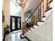 Grand foyer with marble floors, chandelier, and staircase with decorative railings at 5621 Landale Ct, Concord, NC 28027