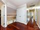 Upstairs hallway with rich hardwood floors and closet with double doors overlooks foyer at 5621 Landale Ct, Concord, NC 28027