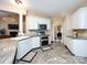 Well-lit kitchen with stainless steel appliances, granite countertops, and white cabinetry at 5621 Landale Ct, Concord, NC 28027