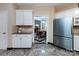 Bright kitchen features stainless refrigerator, white cabinets, and tile backsplash at 5621 Landale Ct, Concord, NC 28027