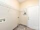 Laundry room with tile flooring, shelving, and exterior door at 5621 Landale Ct, Concord, NC 28027