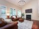 Living room featuring a fireplace, large windows, and hardwood floors at 5621 Landale Ct, Concord, NC 28027