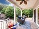 Covered back porch featuring outdoor seating, ceiling fan, and views of backyard at 5621 Landale Ct, Concord, NC 28027