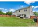 Large, well-maintained backyard featuring a stone patio, fire pit, and privacy fence at 575 Marthas View Nw Dr, Huntersville, NC 28078