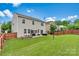 Spacious fenced backyard with a patio featuring a fire pit and outdoor furniture, perfect for entertaining at 575 Marthas View Nw Dr, Huntersville, NC 28078