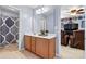Bathroom with a light wood vanity and sink, mirror, shower, and view into the living room at 575 Marthas View Nw Dr, Huntersville, NC 28078