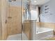 Bright bathroom featuring a glass-enclosed shower and a separate soaking tub at 575 Marthas View Nw Dr, Huntersville, NC 28078