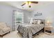 Bedroom featuring a gray bed, bedside tables with lamps, and a comfortable chair at 575 Marthas View Nw Dr, Huntersville, NC 28078