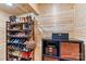 Closet featuring a wooden walls and a metal shoe rack filled with an assortment of shoes and handbags at 575 Marthas View Nw Dr, Huntersville, NC 28078