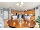Dining area with wood table, seating for four, pendant lighting, and access to the gourmet kitchen at 575 Marthas View Nw Dr, Huntersville, NC 28078