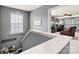 Hallway with gray walls and white trim leading into a room with a desk, chair, and ceiling fan at 575 Marthas View Nw Dr, Huntersville, NC 28078