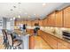 Modern kitchen with wood cabinetry, granite countertops, stainless steel appliances, and pendant lighting at 575 Marthas View Nw Dr, Huntersville, NC 28078