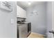 Well-organized laundry room with modern washer and dryer units and ample storage space at 575 Marthas View Nw Dr, Huntersville, NC 28078