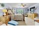 Bright main bedroom featuring a large bed, ceiling fan, and natural light streaming through the windows at 575 Marthas View Nw Dr, Huntersville, NC 28078