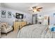 Comfortable main bedroom with ceiling fan, large TV and seating area with stylish decor at 575 Marthas View Nw Dr, Huntersville, NC 28078