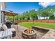 Inviting patio with a fire pit, outdoor seating, and a grill, perfect for outdoor gatherings at 575 Marthas View Nw Dr, Huntersville, NC 28078