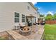 Cozy outdoor patio area featuring a fire pit, comfortable seating, and a barbecue grill at 575 Marthas View Nw Dr, Huntersville, NC 28078