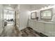 A spacious bathroom offers double sinks, wood-look tile flooring and a glass shower at 5868 Savona Ter, Fort Mill, SC 29708