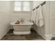 A bright bathroom features a freestanding tub, subway tile walls and a wall-mounted towel rack at 5868 Savona Ter, Fort Mill, SC 29708