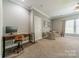 Spacious bedroom featuring a workstation, chair, and two sitting chairs near a window at 5868 Savona Ter, Fort Mill, SC 29708