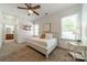 Well-lit bedroom with ceiling fan, windows, and neutral decor creates a relaxing atmosphere at 5868 Savona Ter, Fort Mill, SC 29708