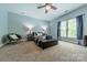 A relaxing bedroom featuring gray walls, large windows and a ceiling fan at 5868 Savona Ter, Fort Mill, SC 29708