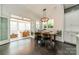 Dining area featuring a wooden table, stylish chairs, and access to screened-in back porch at 5868 Savona Ter, Fort Mill, SC 29708
