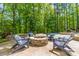 Backyard patio with a stone firepit and wooded views at 5868 Savona Ter, Fort Mill, SC 29708
