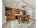 Entertainers kitchenette with wood cabinetry, lighting, dining table, and comfortable seating at 5868 Savona Ter, Fort Mill, SC 29708