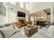 Bright living room featuring a stone fireplace, hardwood floors, and an open floor plan at 5868 Savona Ter, Fort Mill, SC 29708